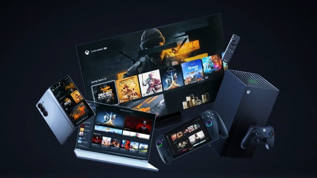 alt="Vários dispositivos, incluindo Smart TV, notebook, celular dobrável e console portátil, exibindo a interface do Xbox Cloud Gaming flutuando em um fundo escuro."